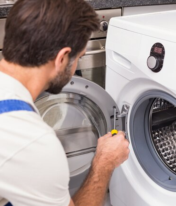 A skilled technician from Upper Appliance repairs a dryer in a residential home, ensuring trusted and reliable dryer repair services in Houston. Trusted Dryer Repair Services