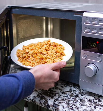Skilled technicians diagnose microwave heating, sparking and power issues with precision. Technician Diagnosing Microwave Issues
