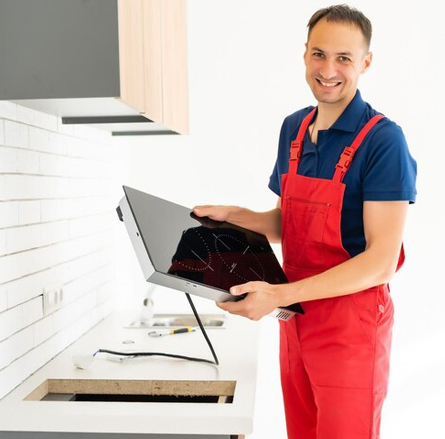 A reliable electric stove repair service in progress, with a technician fixing electrical components to restore proper function. Reliable Electric Stove Repair